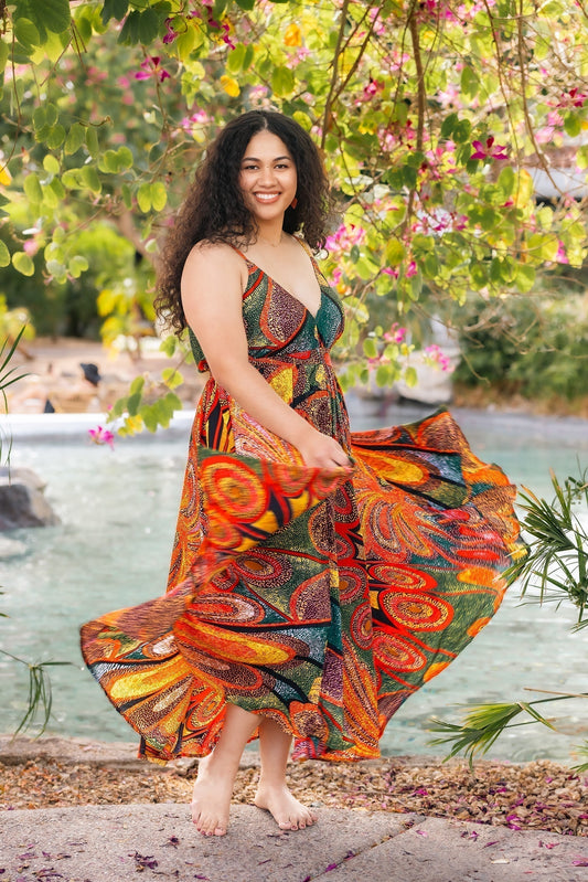 young lady in bright orange and green dress